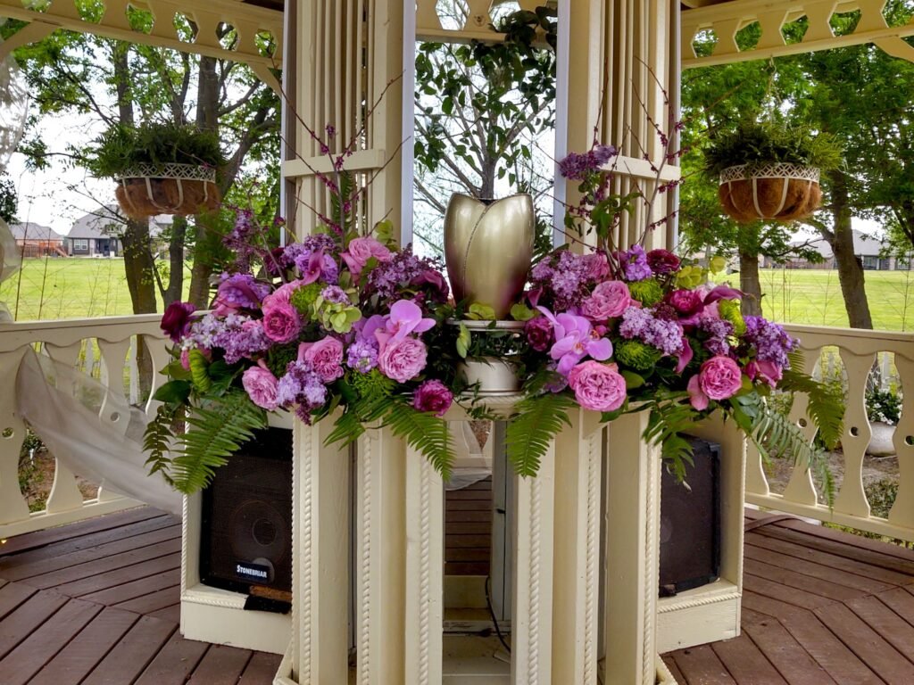 Bedazzled urn and floral centerpieces on location for DIY Celebration of Life Ceremony