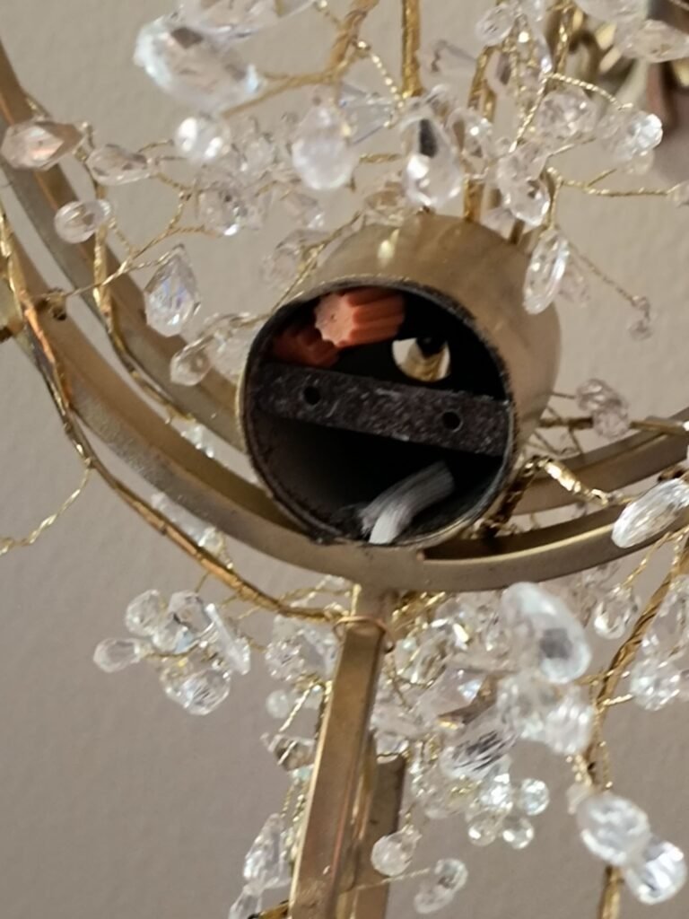 Close up of hole created in DIY Raindrop chandelier when top piece was removed