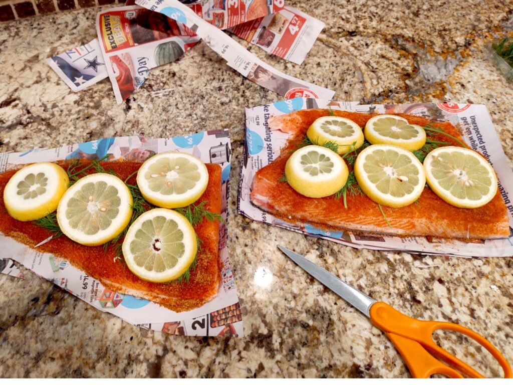 Easy dinner party food; raw salmon with lemon and dill being prepped for the grill