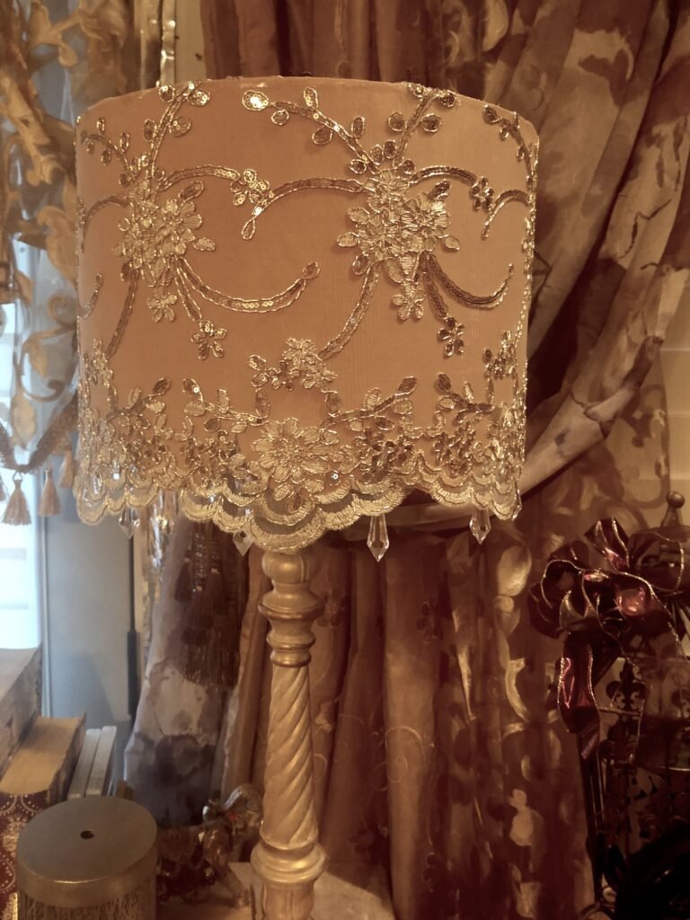 Blush colored drum style lampshade with gold embroidery lace and sequins, scalloped edge at the bottom of the shade