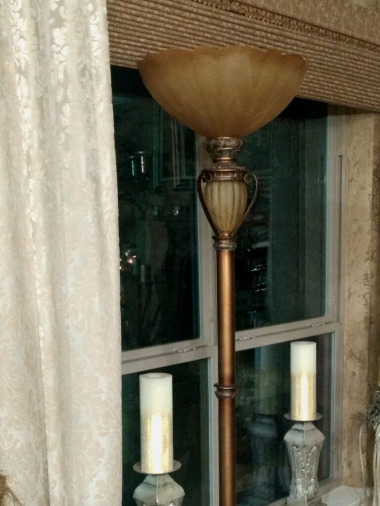 Old style floor lamp with amber colored glass shade