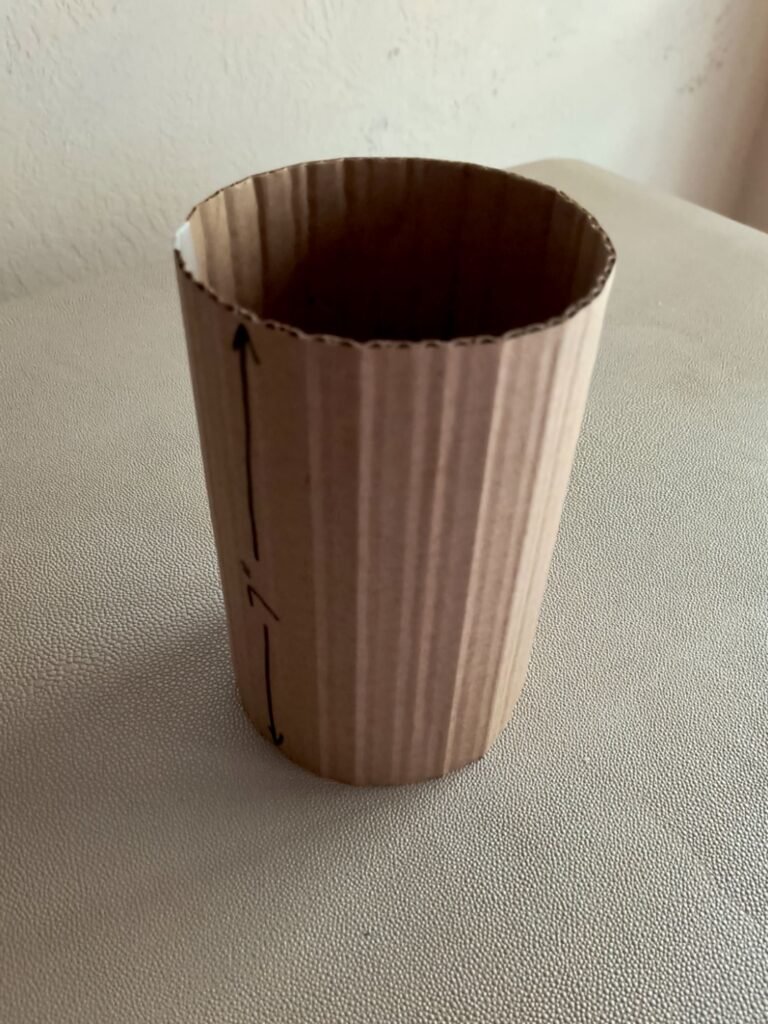 New gift wrapping ideas showing a DIY taller piece of cardboard rolled to make a 7" tall tube