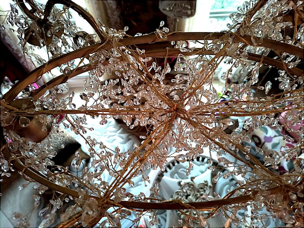 Close up all all crystal strands coming together at the center of DIY raindrop chandelier