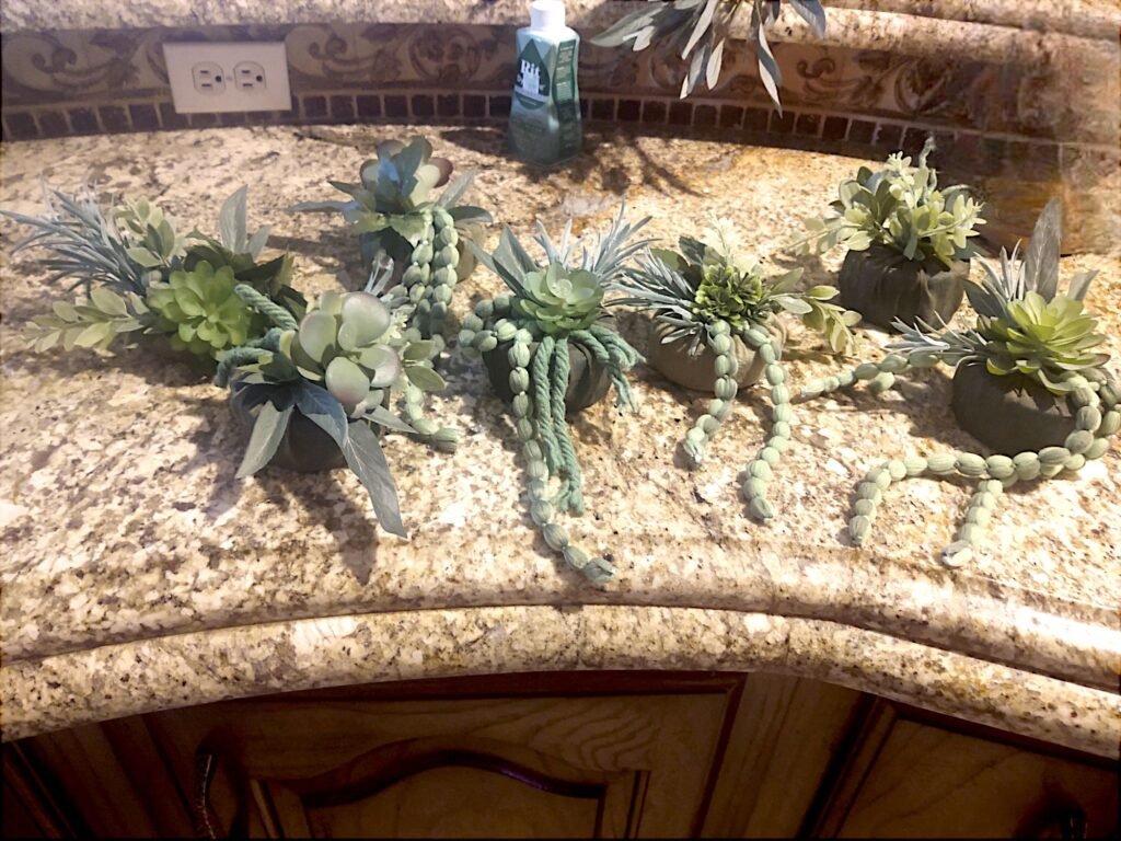 Mini plantings using faux succulents to be glued to the green wall